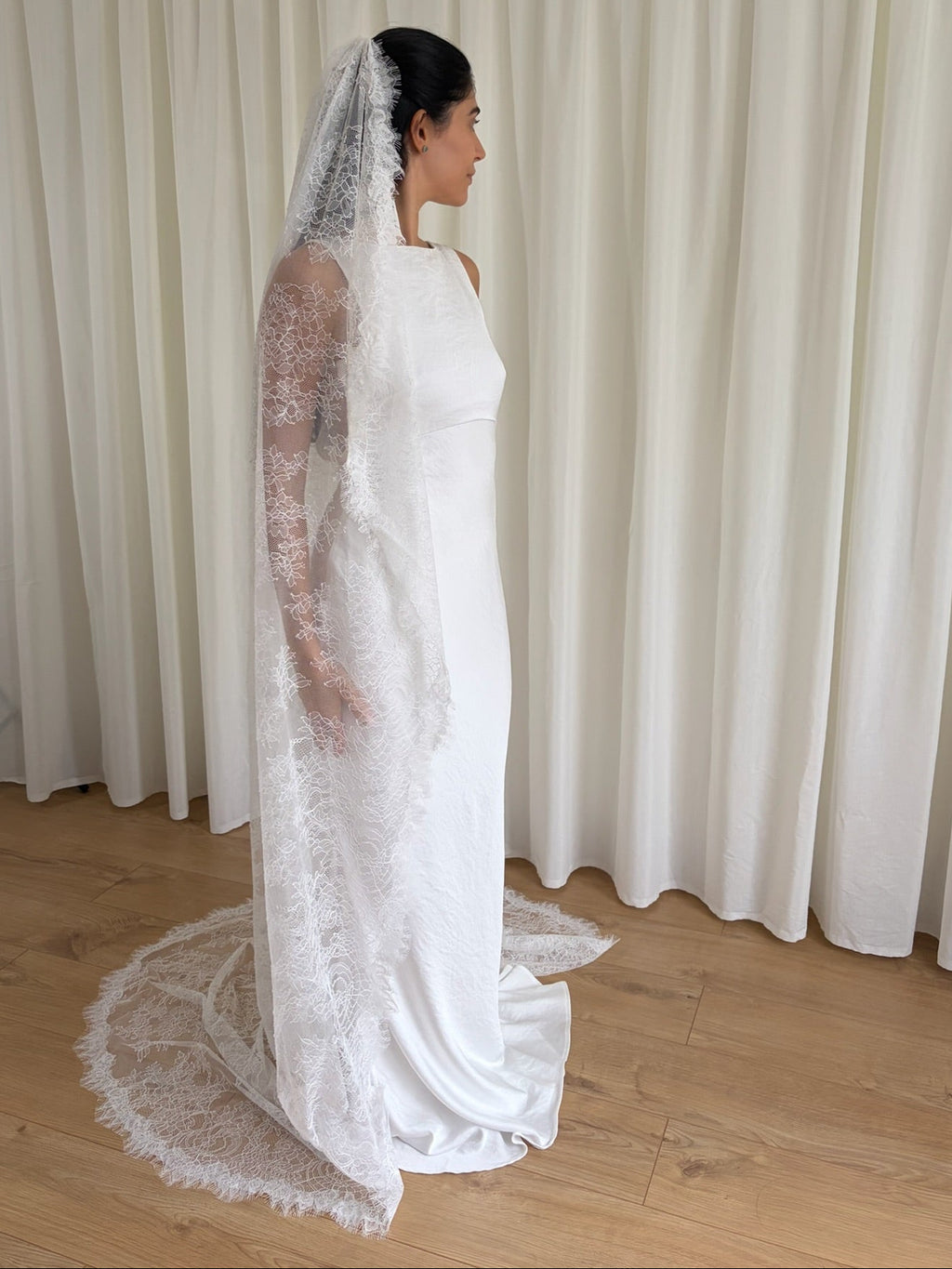 Cathedral-length bridal veil made from soft off-white tulle with full Chantilly lace all over. Lightweight, romantic, and beautifully detailed for a timeless bridal look.