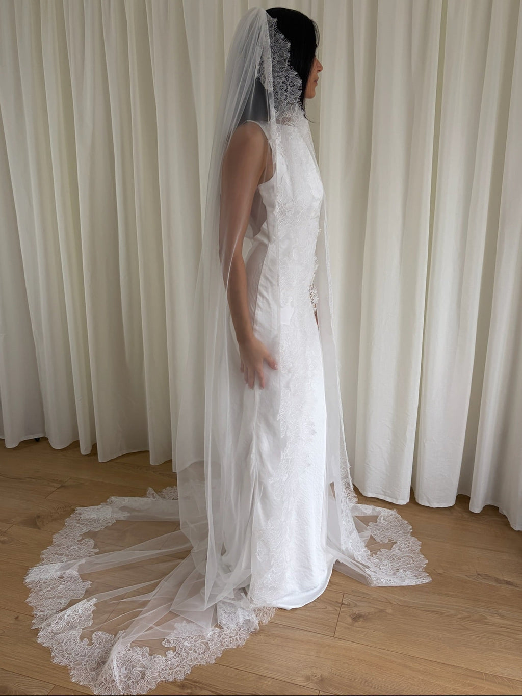 Cathedral-length wedding veil crafted from soft off-white tulle with an intricate Chantilly lace trim, ideal for brides wanting a romantic, elegant bridal accessory