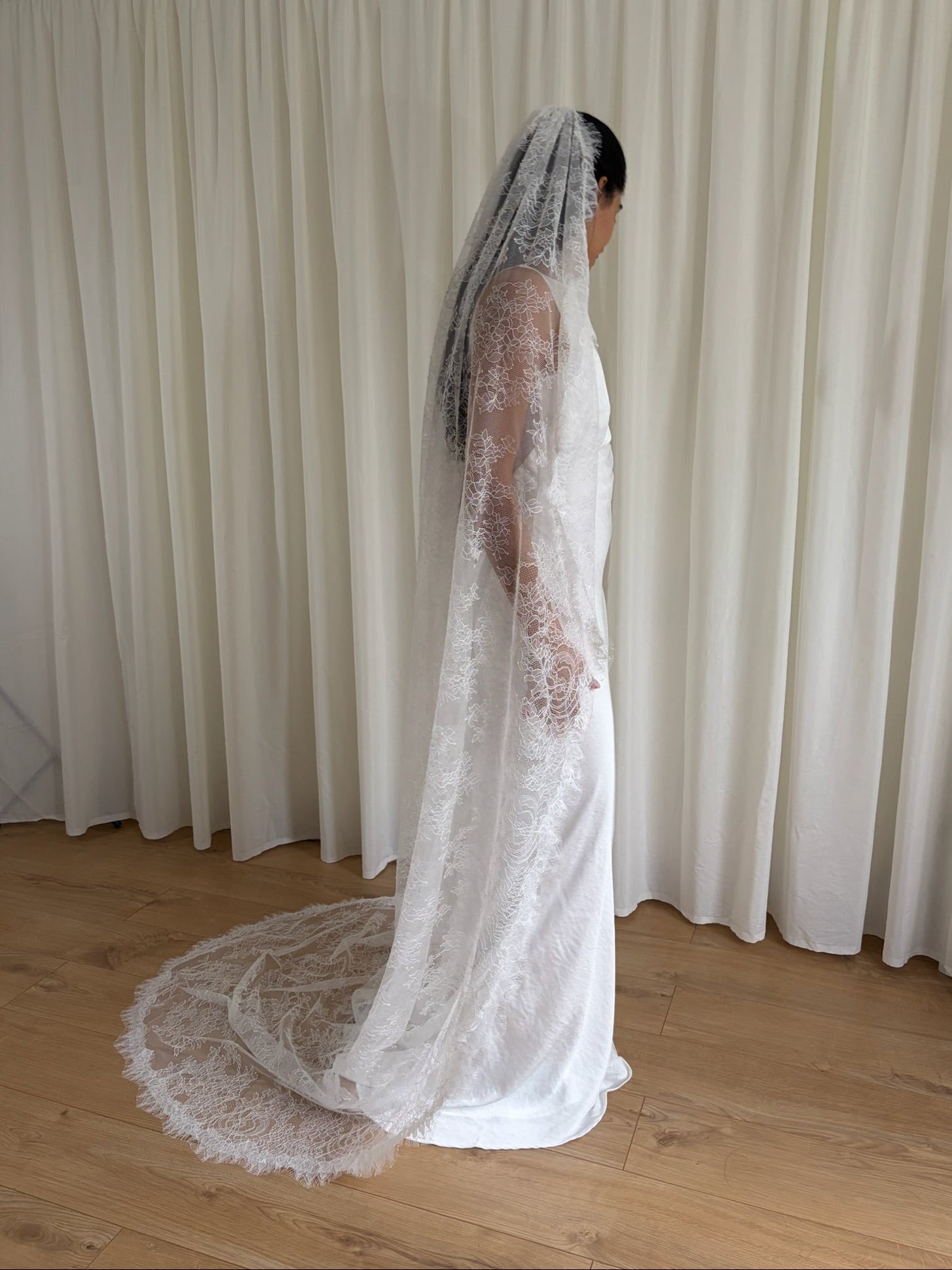 Cathedral-length bridal veil made from soft off-white tulle with full Chantilly lace all over. Lightweight, romantic, and beautifully detailed for a timeless bridal look.