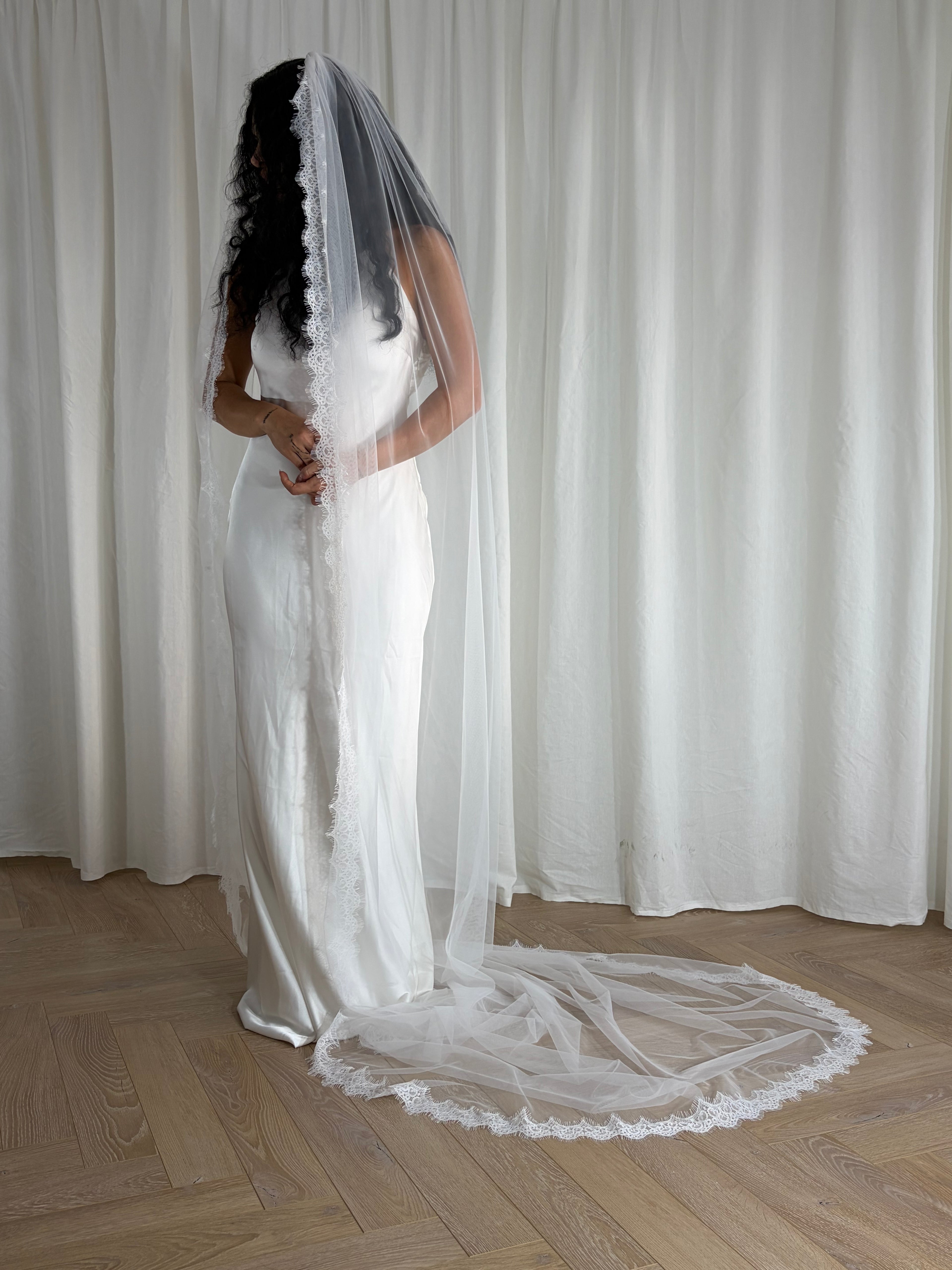 Single-tier vintage lace trim cathedral veil with a soft, cloak-like fall in lightweight tulle — romantic and ethereal bridal design.