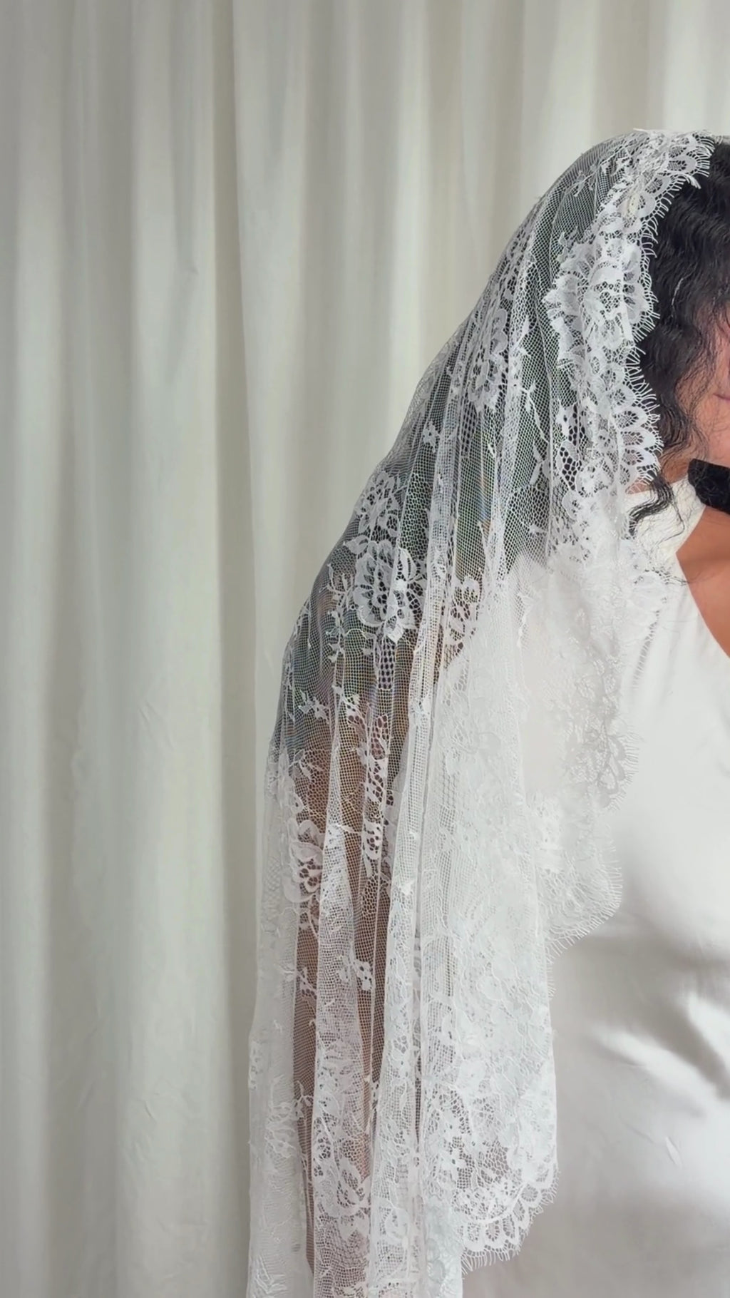 The Mantilla-Style Chantilly Rose Full Lace Veil is a cathedral-length bridal statement piece, designed for timeless elegance. Made from soft, lightweight tulle, it features intricate Chantilly rose lace that frames the veil completely, creating a delicate, romantic finish. The veil drapes beautifully straight to the ground, evoking a graceful, ethereal silhouette.This a vintage take on spanish style mantilla veil.