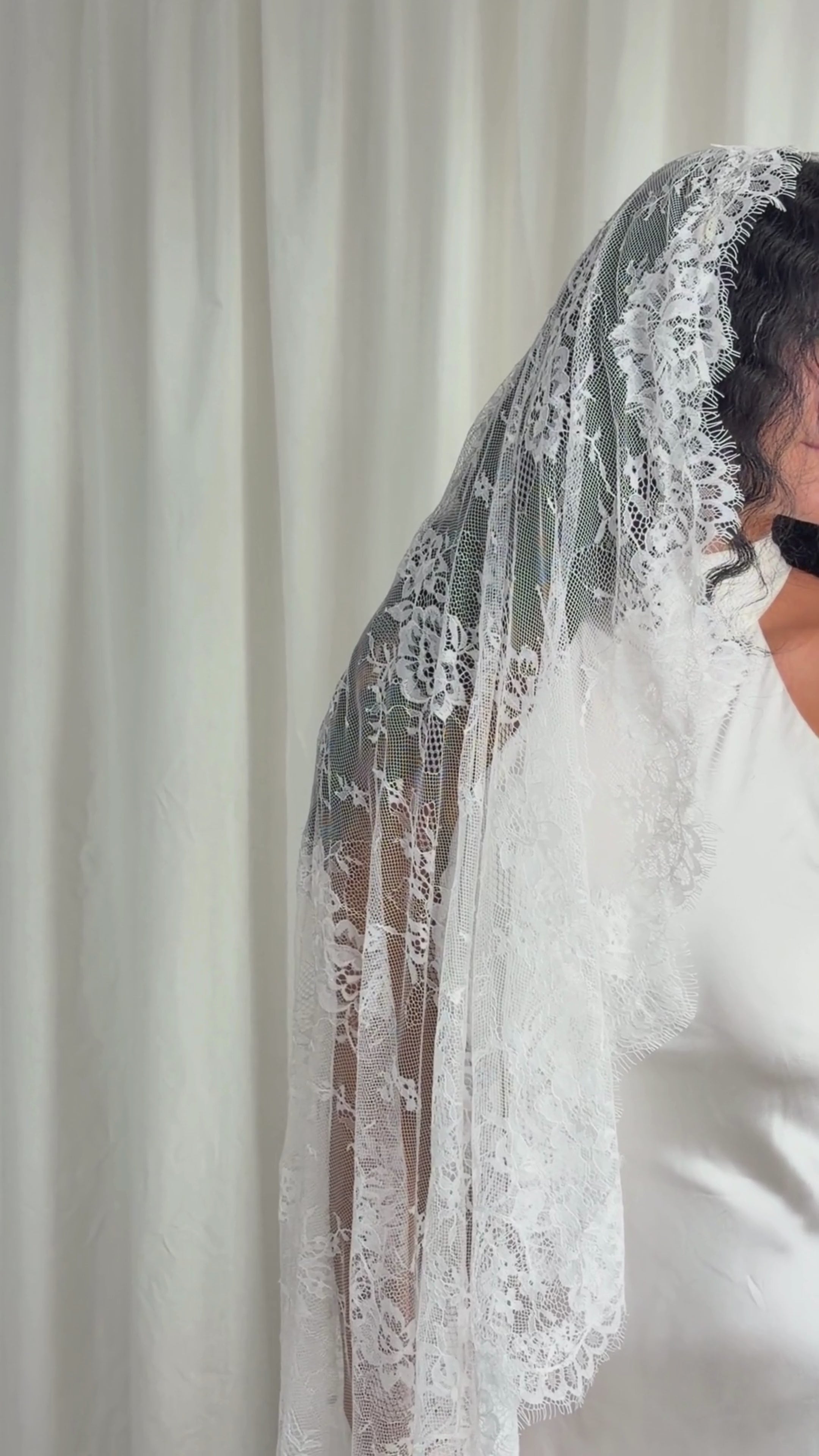 The Mantilla-Style Chantilly Rose Full Lace Veil is a cathedral-length bridal statement piece, designed for timeless elegance. Made from soft, lightweight tulle, it features intricate Chantilly rose lace that frames the veil completely, creating a delicate, romantic finish. The veil drapes beautifully straight to the ground, evoking a graceful, ethereal silhouette.This a vintage take on spanish style mantilla veil.