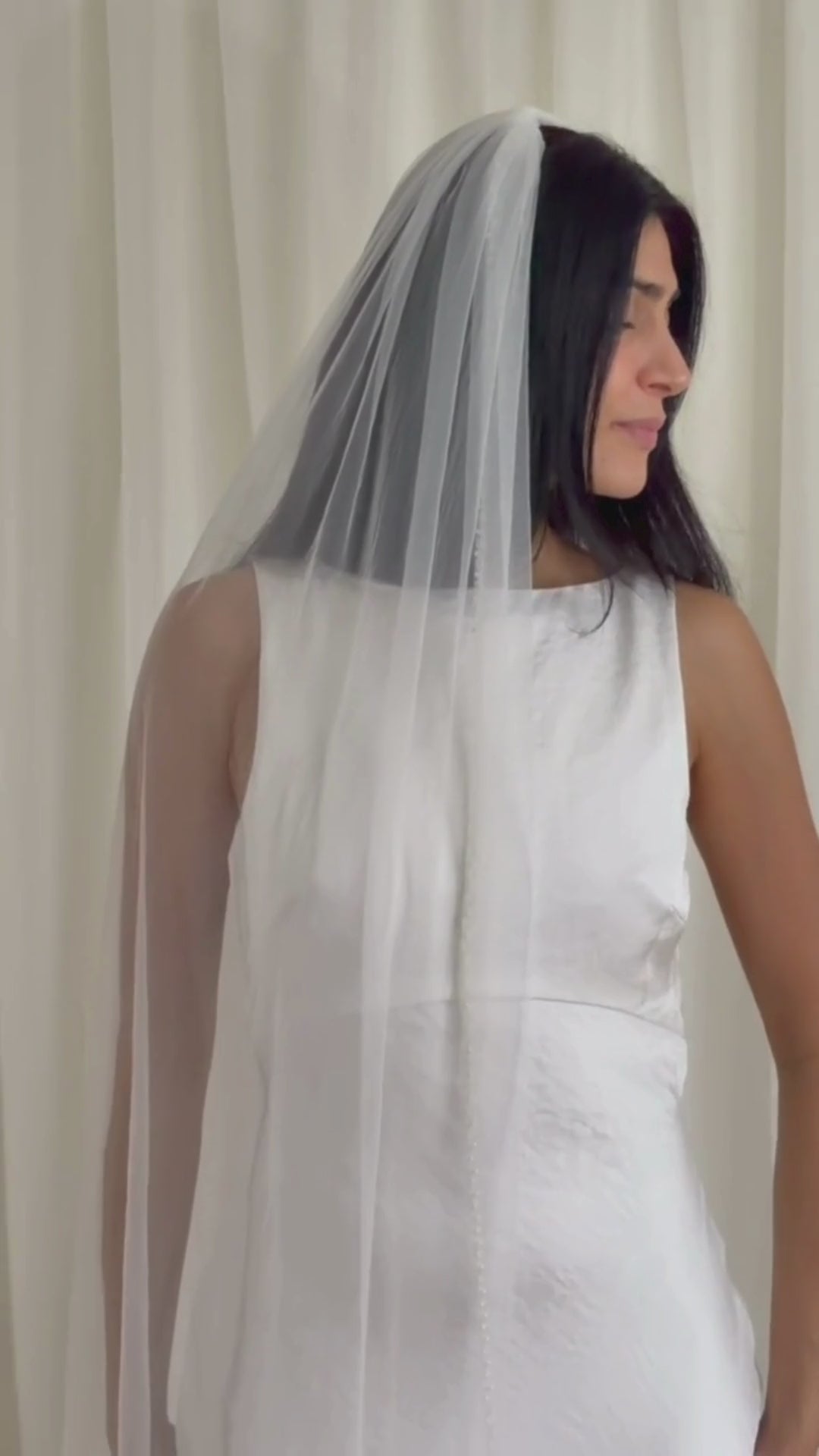 Soft tulle wedding veil with hand-placed pearl trim, perfect for modern and classic brides seeking an elegant bridal accessory