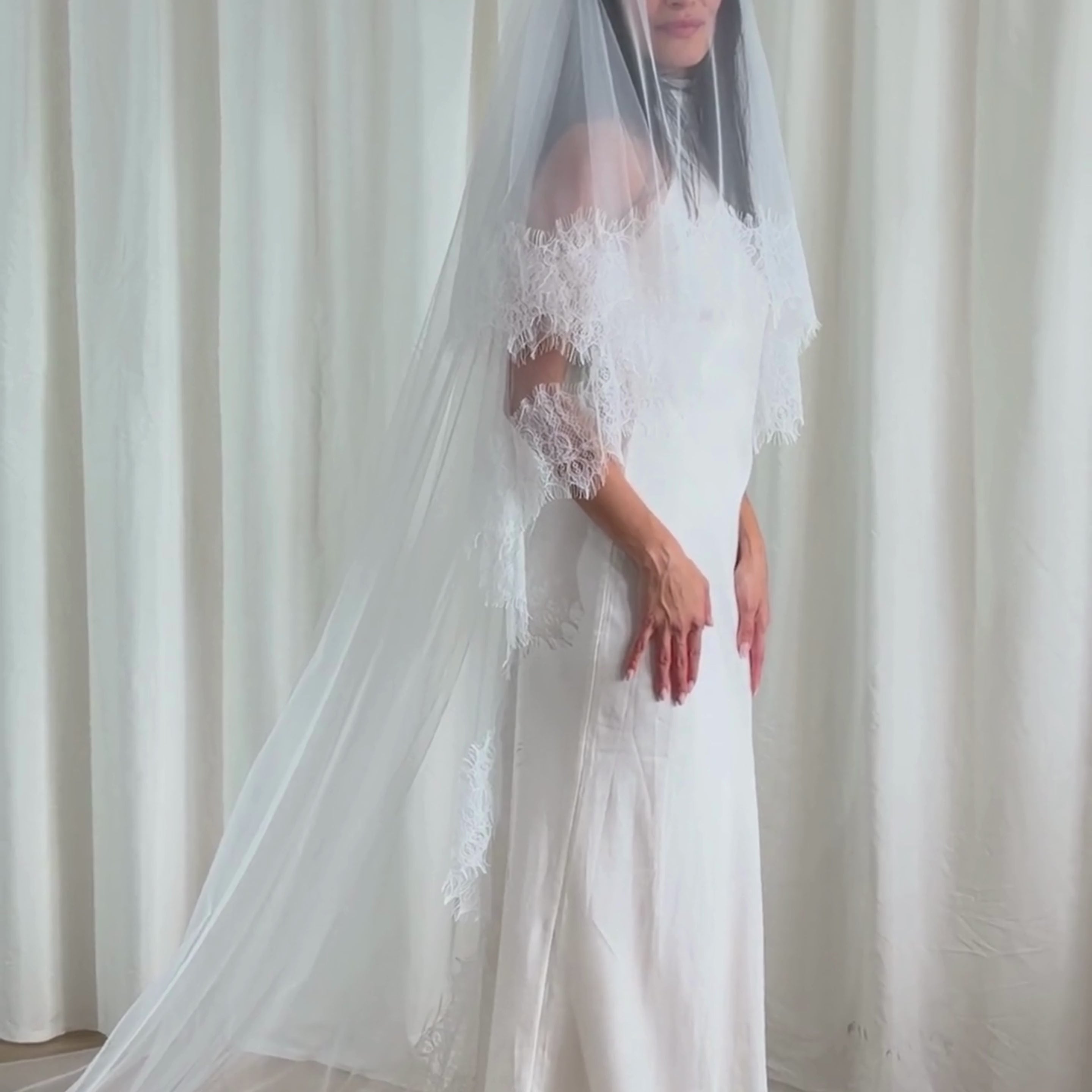This vintage romantic blusher lace trim veil captures timeless bridal elegance. Made from luxuriously soft tulle, it features a delicate lace edge that frames the face and gown with effortless grace. The blusher layer adds a hint of vintage charm, creating a soft, ethereal silhouette ideal for traditional, chapel, or cathedral-length weddings. Perfect for brides seeking a romantic, classic look with refined detail and a seamless, airy drape.
