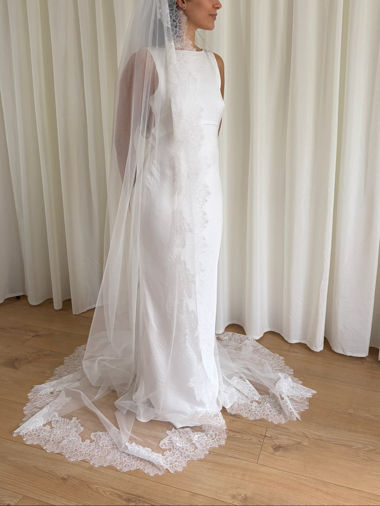 Cathedral-length wedding veil crafted from soft off-white tulle with an intricate Chantilly lace trim, ideal for brides wanting a romantic, elegant bridal accessory