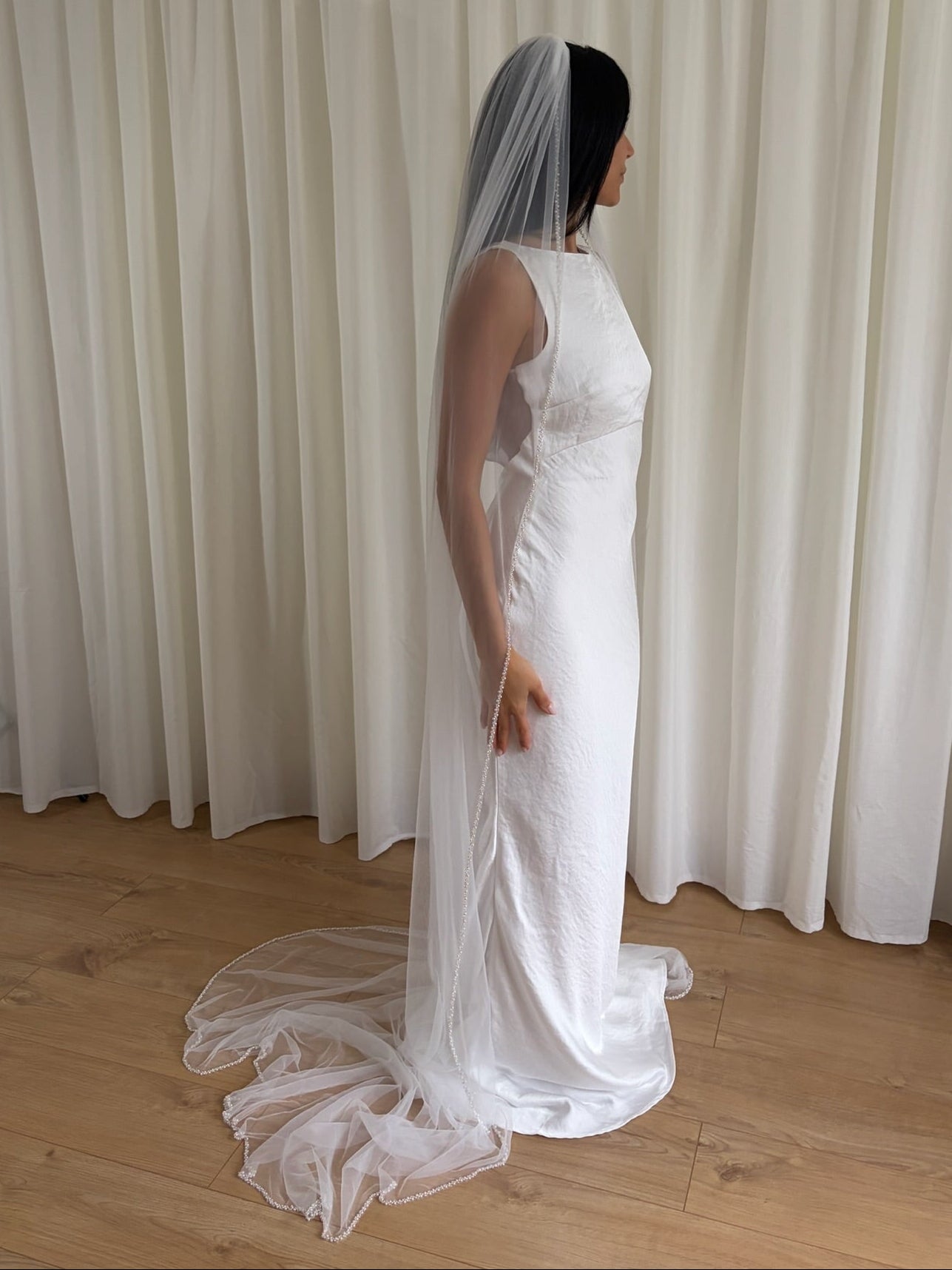 Soft tulle wedding veil with hand-placed pearl trim, perfect for modern and classic brides seeking an elegant bridal accessory
