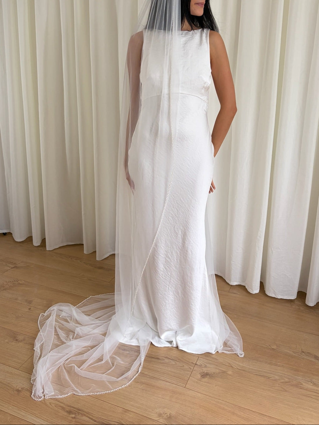 Soft tulle wedding veil with hand-placed pearl trim, perfect for modern and classic brides seeking an elegant bridal accessory